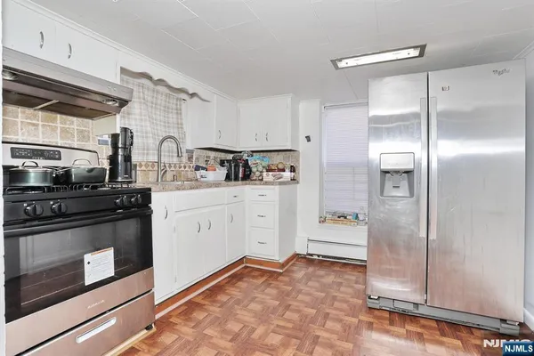 a kitchen with a sink stove and refrigerator