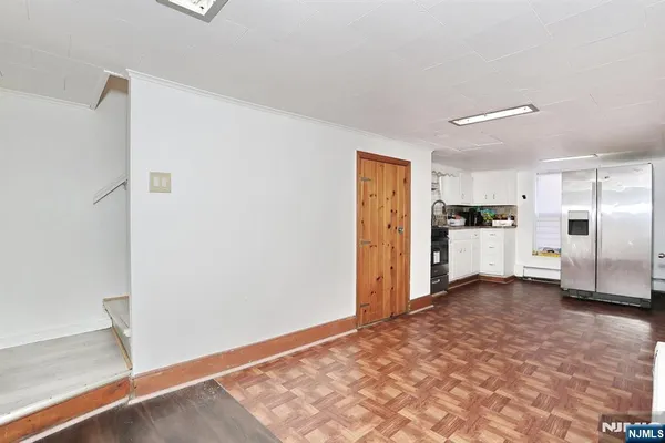 a view of a kitchen with a refrigerator and a stove top oven