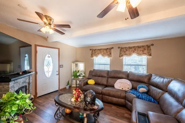 a living room with furniture a flat screen tv and a window