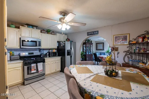 a kitchen with stainless steel appliances granite countertop a sink dishwasher a stove a microwave oven with cabinets and wooden floor