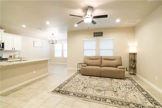 a living room with furniture and a chandelier