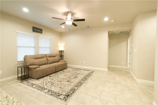 a living room with a couch and chandelier