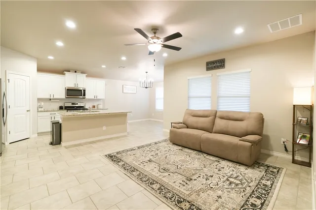 a living room with furniture and kitchen view