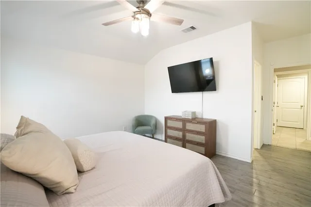 a bedroom with a bed and a flat screen tv