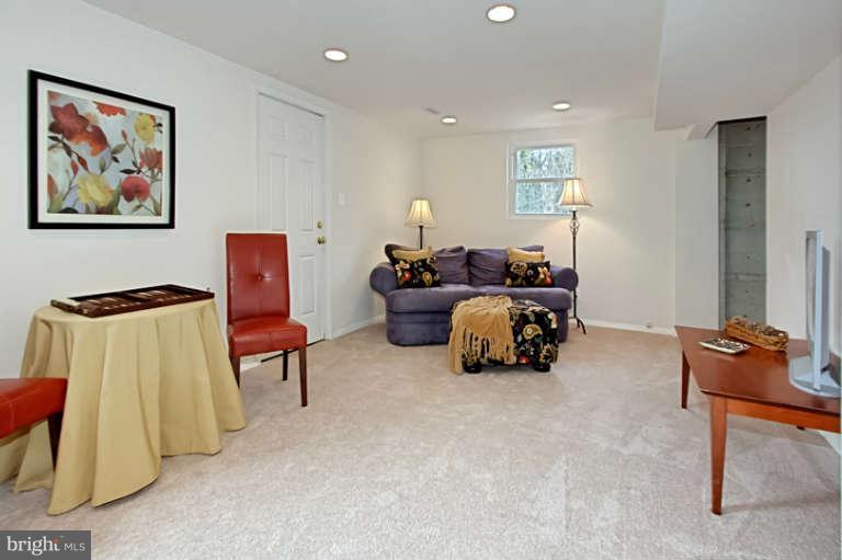 7632 Dunston Street Springfield, VA 22151 - Photo 22 of 30 a bed room with furniture and a chair