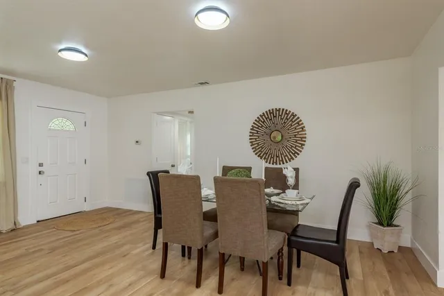 a view of a dining room with furniture and wooden floor