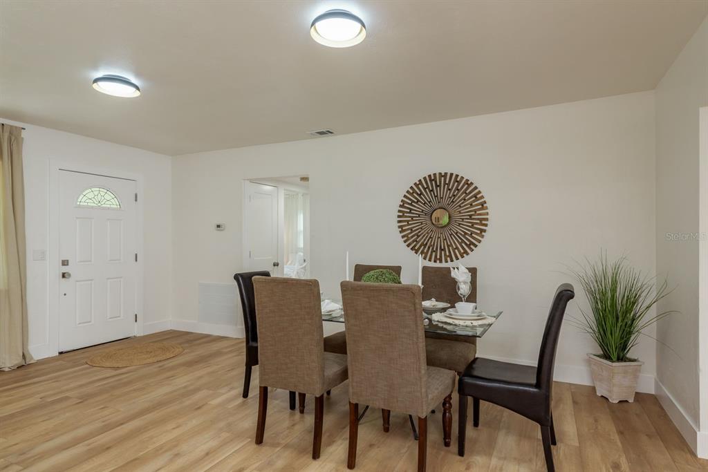 1448 Lemon Street Clearwater, FL 33756 - Photo 11 of 33 a view of a dining room with furniture and wooden floor