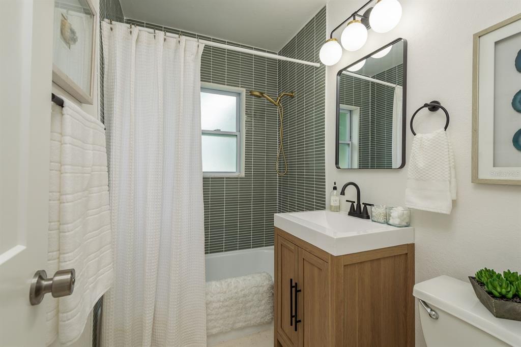 1448 Lemon Street Clearwater, FL 33756 - Photo 20 of 33 a bathroom with a sink vanity granite and a mirror
