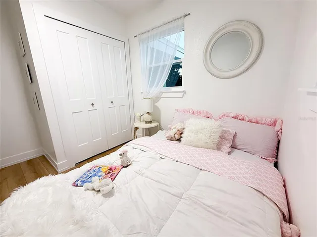 a bedroom with a bed and a mirror