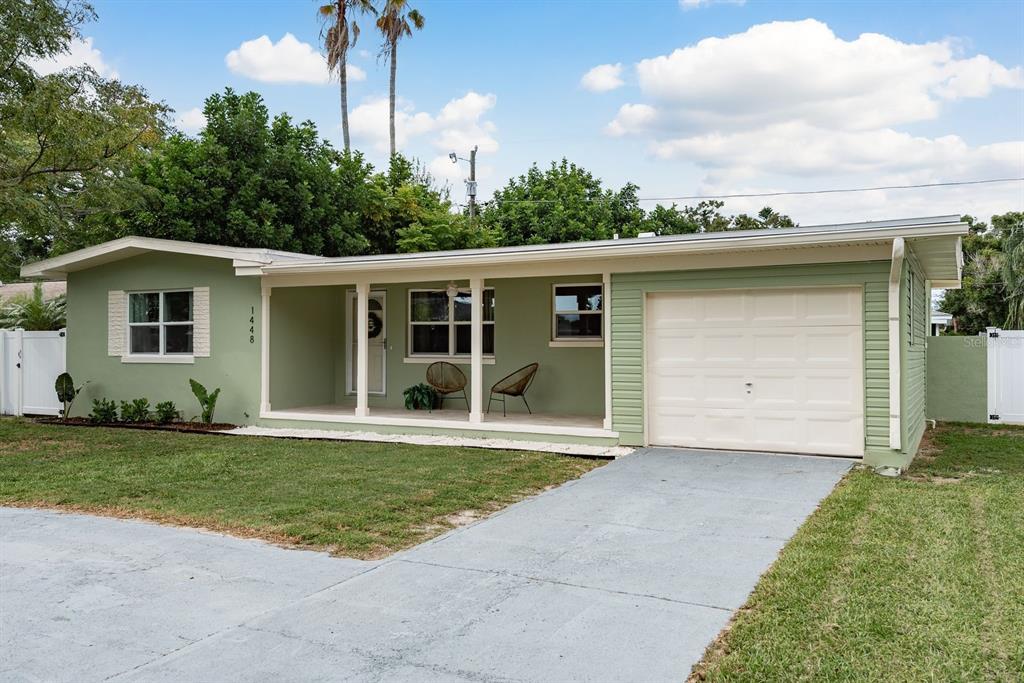 1448 Lemon Street Clearwater, FL 33756 - Photo 3 of 33 a front view of a house with a yard and garage