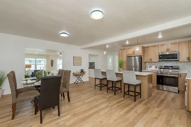 a view of a dining room with furniture window and wooden floor