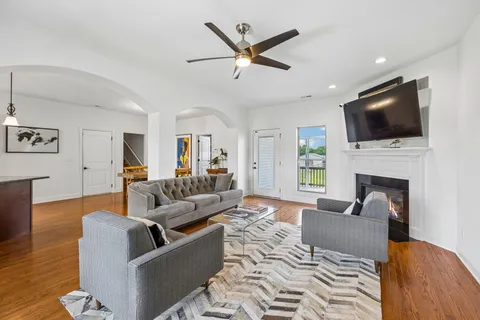a living room with fireplace furniture and a flat screen tv