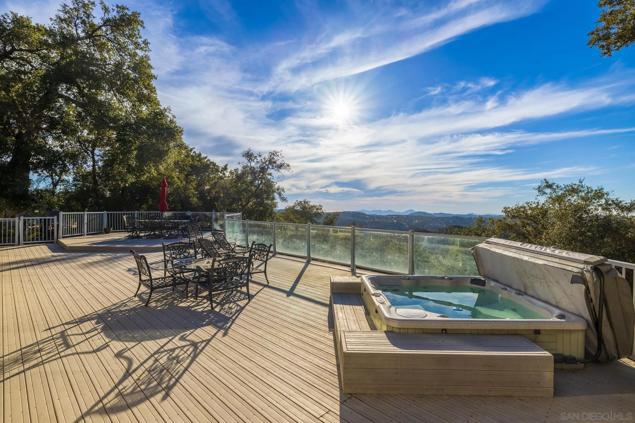 1634 Oakforest Road Santa Ysabel, CA 92070 - Photo 25 of 61 a view of a patio with dining table and chairs with wooden floor