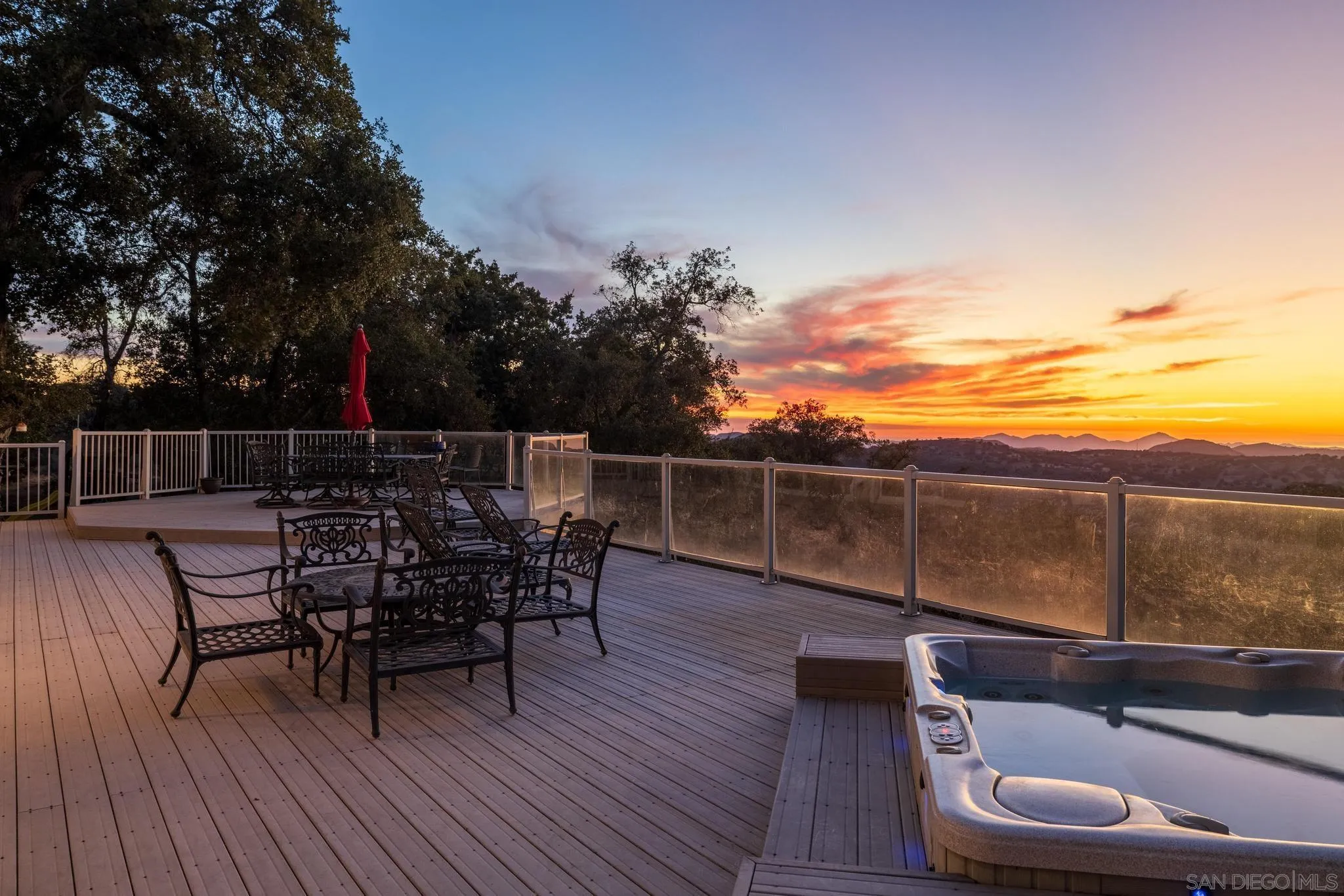 1634 Oakforest Road Santa Ysabel, CA 92070 - Photo 56 of 61 a view of a roof deck with table and chairs with wooden floor and fence