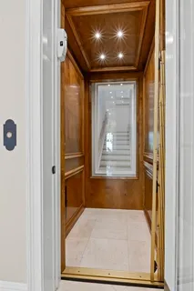 a dining room with chairs and chandelier