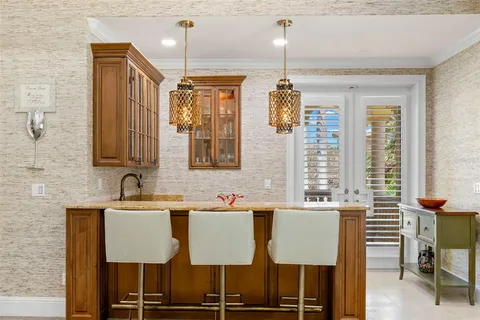 a living room with a couch and a lamp on a dresser