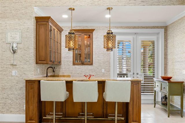 a living room with a couch and a lamp on a dresser
