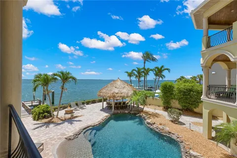 a bedroom with a large bed and a flat screen tv
