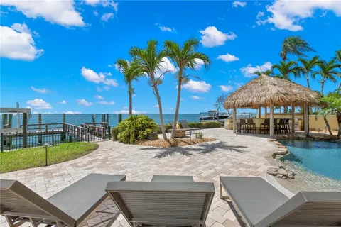 a living room with pool table and a flat screen tv