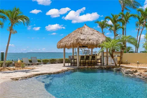 a bathroom with a granite countertop sink a mirror and shower