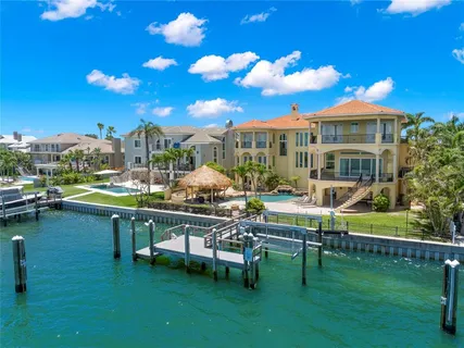 a living room with furniture a flat screen tv and a large window