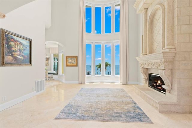 a living room with furniture and large windows