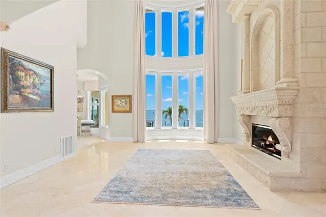 a living room with furniture and large windows