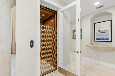 a large white kitchen with a large window and stainless steel appliances
