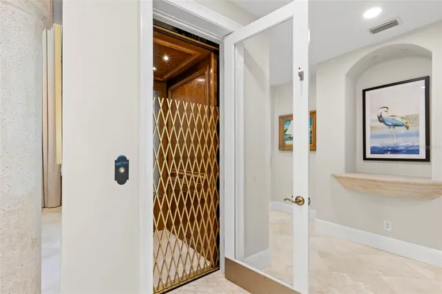 a large white kitchen with a large window and stainless steel appliances