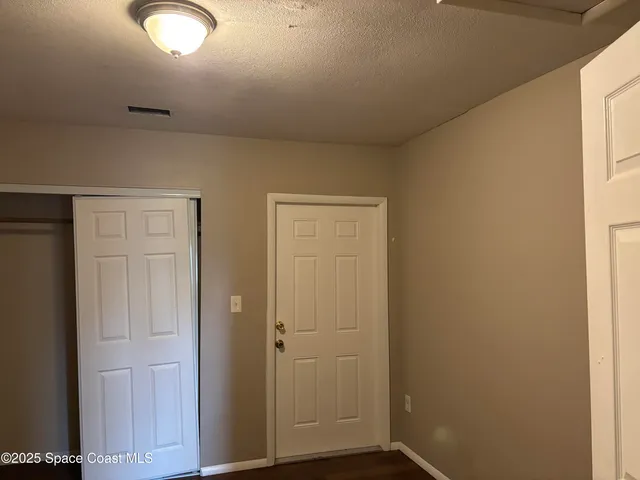 a view of barbeque grill and wooden wall