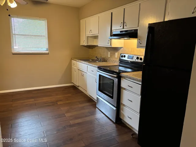 a kitchen with a stove and a refrigerator