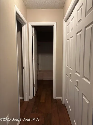 a room with a closet and wooden floor