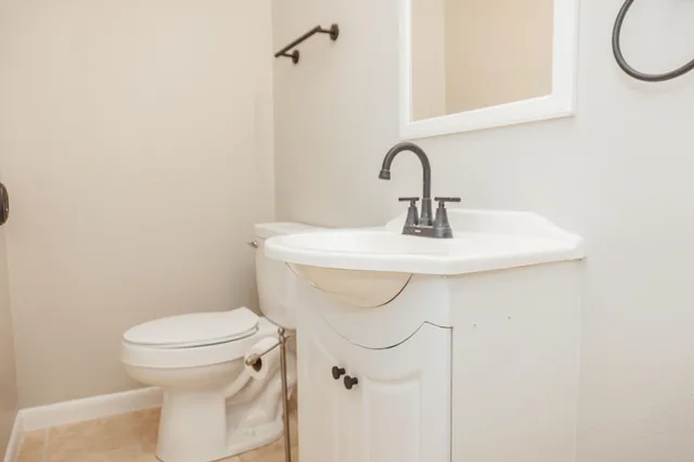 a bathroom with a sink a toilet and a mirror