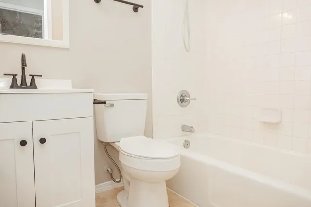 a bathroom with a toilet and a bathtub