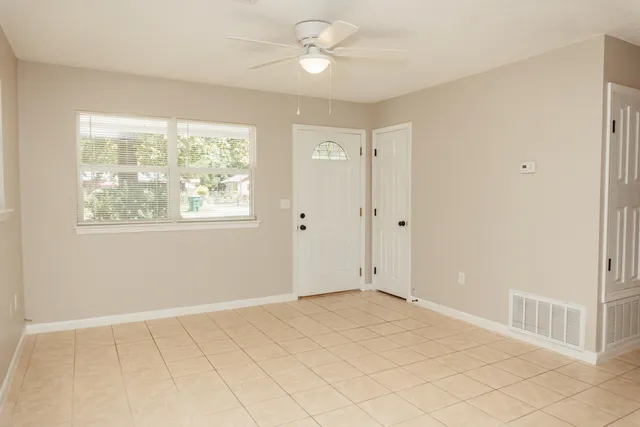 a view of an empty room with a window