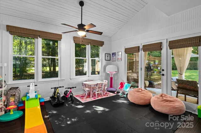 a bedroom with furniture and a large window