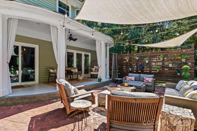 a view of a patio with a dining table and chairs with wooden floor