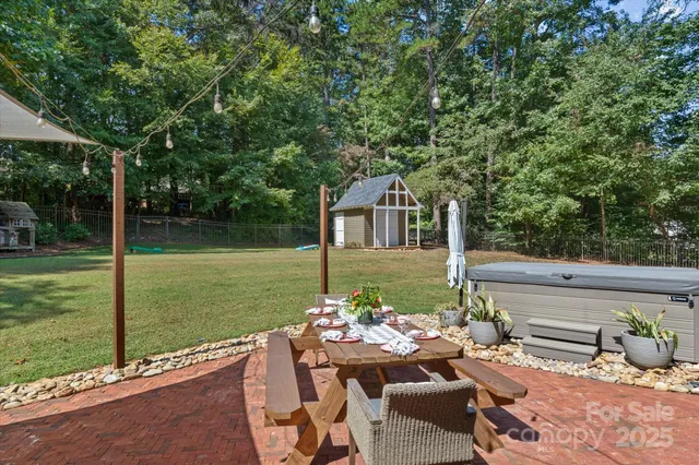 a view of a patio with couches table and chairs and garden