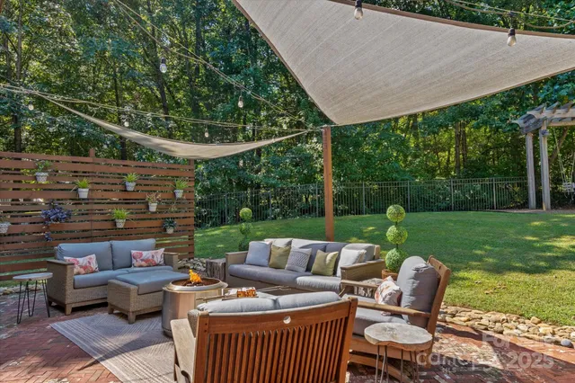 a view of a patio with couches chairs and a yard