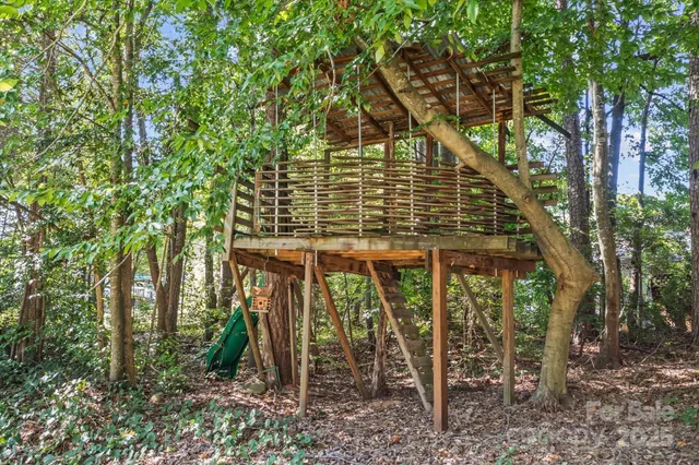 a view of a house with large trees