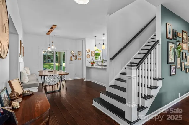a view of entryway dining room and hall with wooden floor
