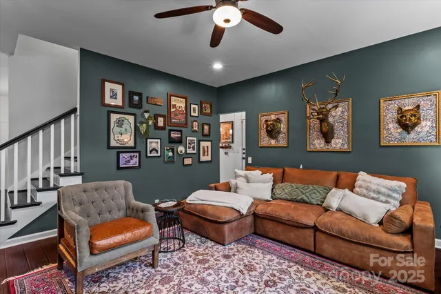 a living room with furniture ceiling fan and a rug