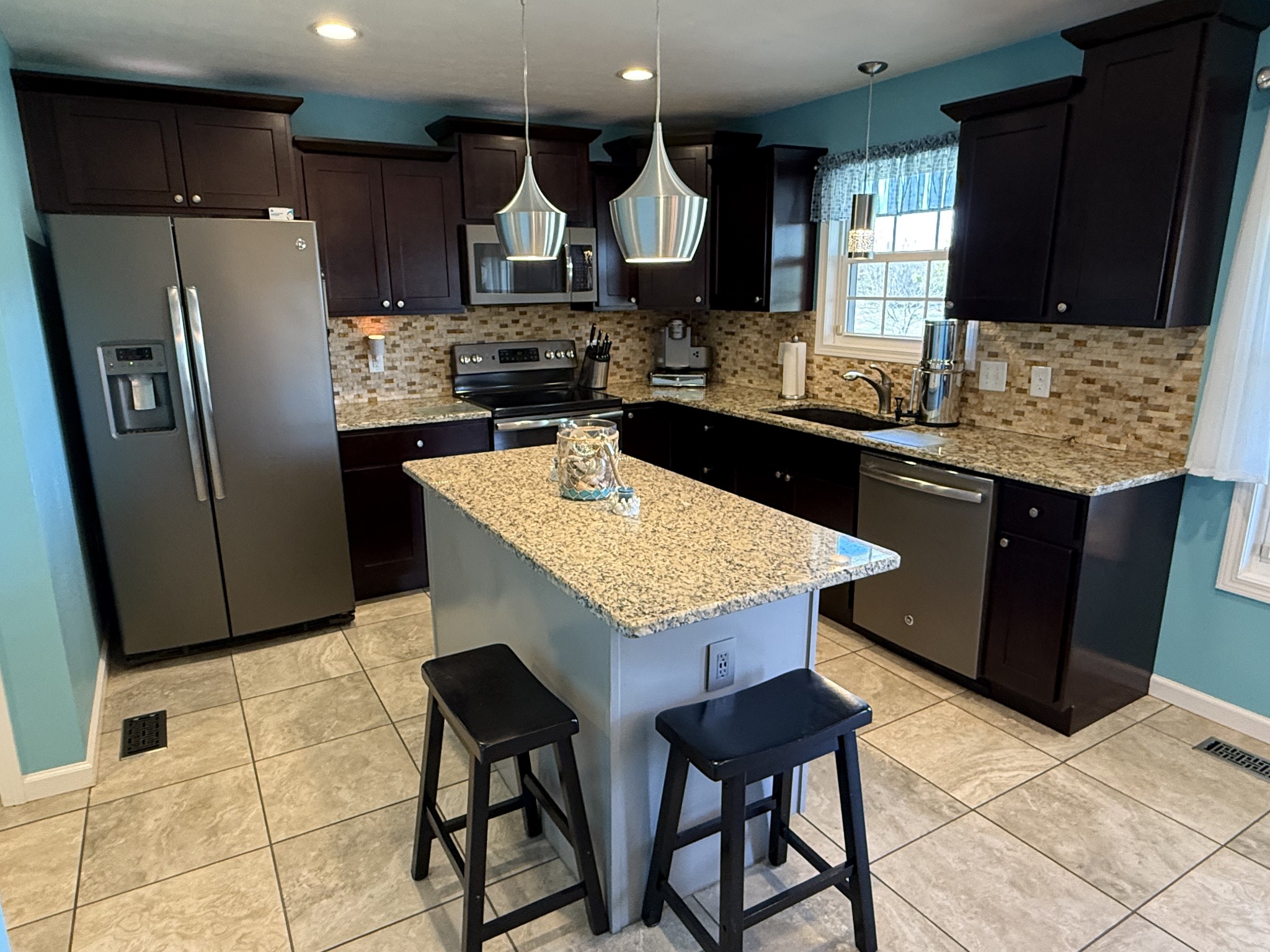 330 North Centerpoint Road Portland, TN 37148 - Photo 19 of 28 a kitchen with stainless steel appliances kitchen island granite countertop a table chairs and a refrigerator
