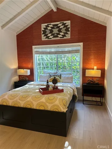 a bed sitting in a bedroom next to a window