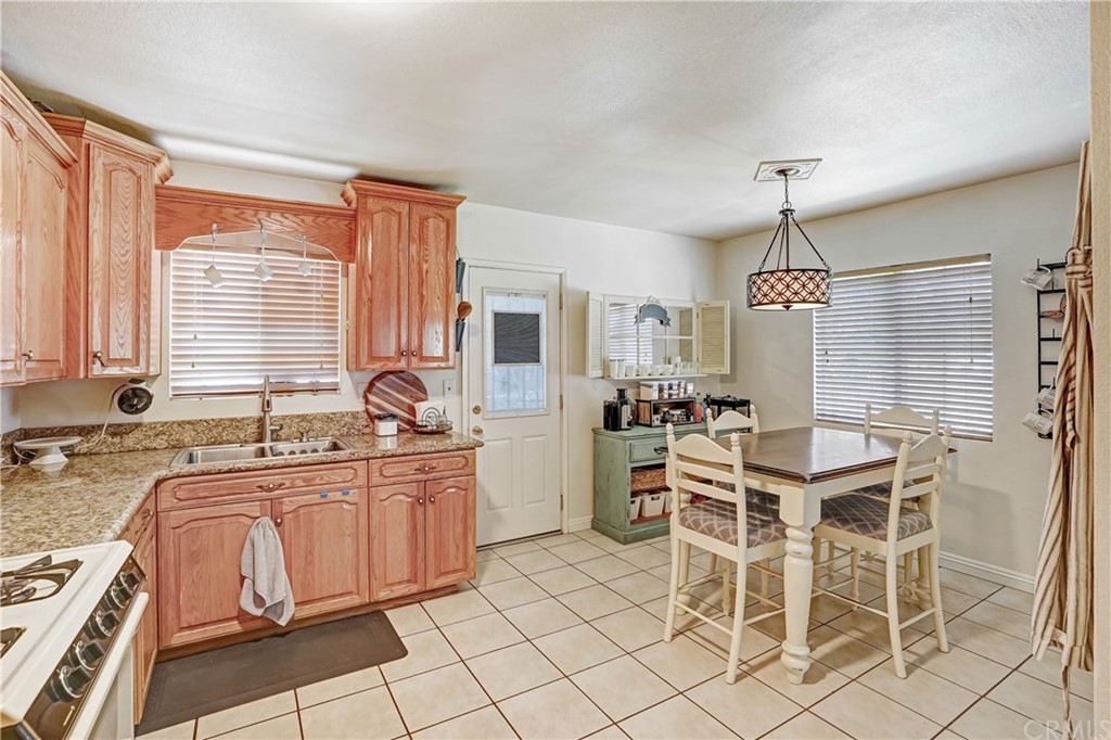 10223 25th Street Rancho Cucamonga, CA 91730 - Photo 11 of 17 a kitchen with granite countertop cabinets and chairs