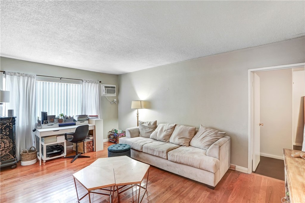 10223 25th Street Rancho Cucamonga, CA 91730 - Photo 5 of 17 a living room with furniture a large window and a table