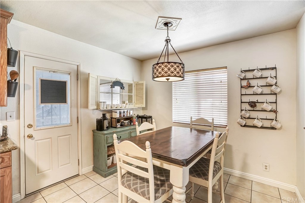 10223 25th Street Rancho Cucamonga, CA 91730 - Photo 6 of 17 a view of a dining room with furniture and chandelier