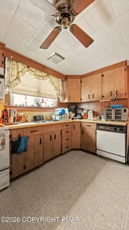 a kitchen with stainless steel appliances granite countertop a stove a sink and white cabinets