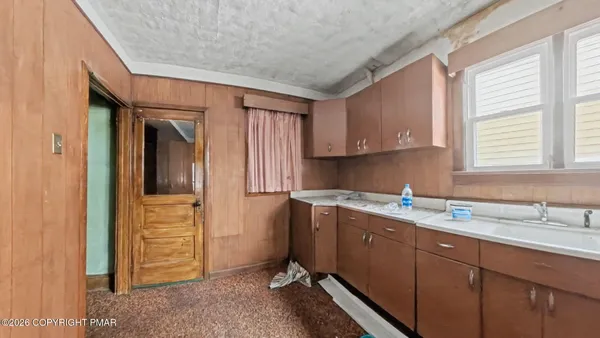 a kitchen with a sink cabinets and window