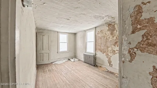 a view of hallway with wooden floor